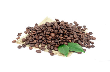 Coffee beans and green leaves on a white background.