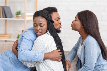 Cheating Afro Man Kissing Another Woman While Hugging With His Wife