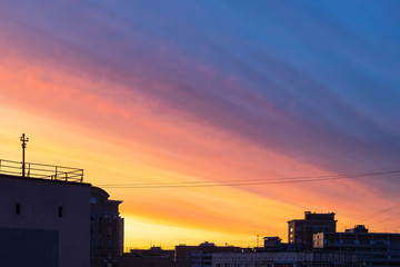 multi-colored sunset sky over apartment houses