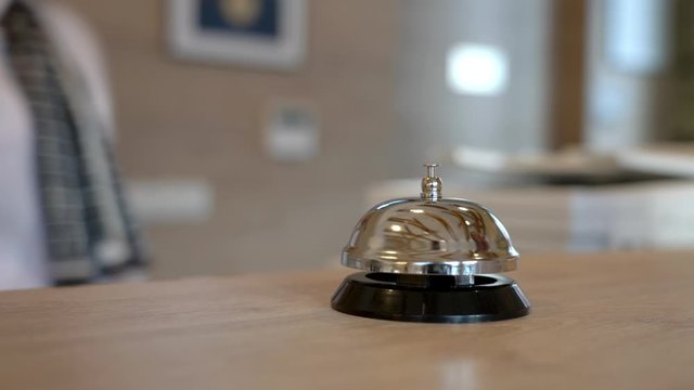 Receptionist assisting hotel guest at desk