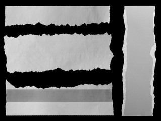 Torn papers on black