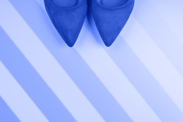 Monochrome pink background with red woman's high heels shoes. Fashion background with copy space. Flat lay. Stripes