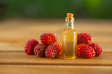 Essence of Wild raspberries  on table in beautiful glass Bottle