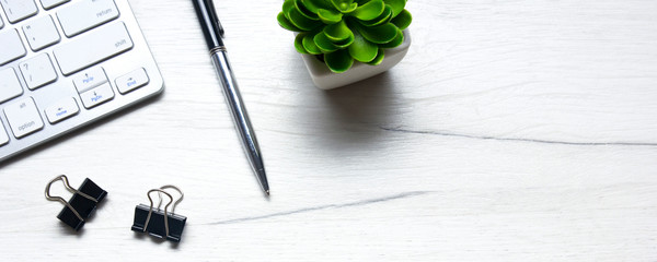 White desk office with laptop, smartphone and other work supplies with cup of coffee. Top view with...