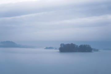 Island in the river with fog