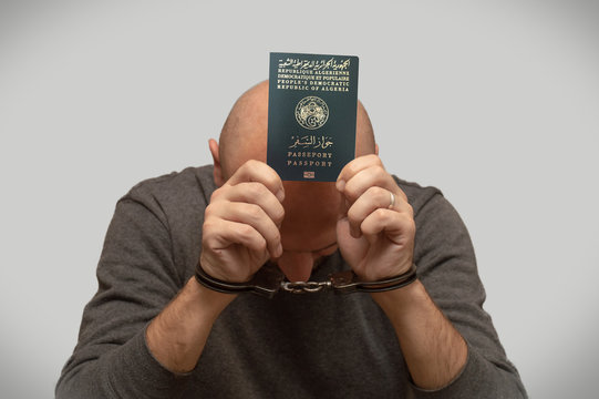 The problem of illegal immigration of refugees from Algeria, Algerian immigrant in handcuffs. Illegal stay in the country.