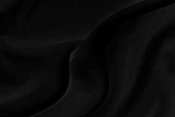 Black gray satin dark fabric texture luxurious shiny that is abstract silk cloth background with patterns soft waves blur beautiful.