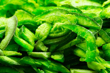 Lot of slices of green marmalade. Front view.