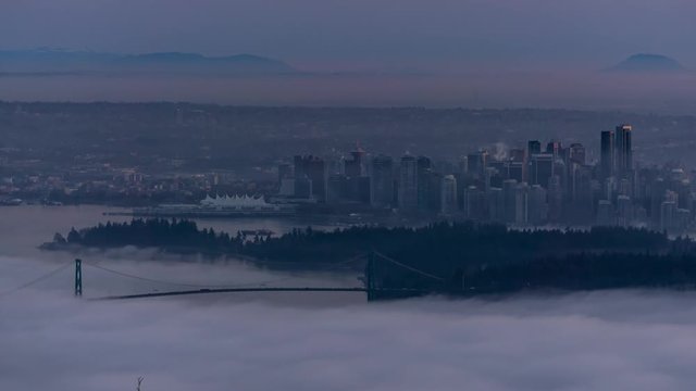 Time Lapse of Downtown Vancouver City Buildings and Stanley Park View. Picture taken during a cloudy evening from Cypress Mountain Viewpoint, West Vancouver, British Columbia, Canada.