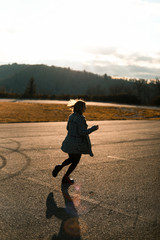Young woman walking away in golden light 