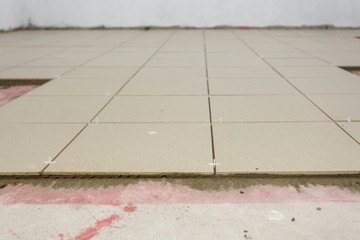 Fragment of the floor, in the process of laying ceramic tiles.