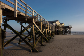 Naklejka premium sand beach with wooden stilt house in Sankt Peter-Ording