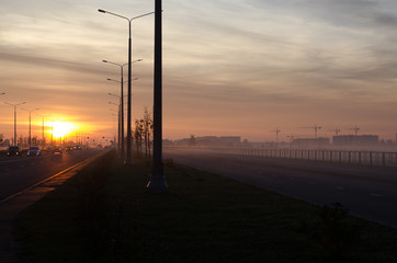 Fototapeta na wymiar sunset on the road with fog