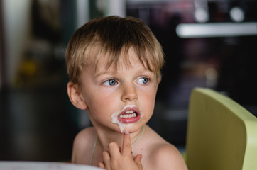 portrait of a boy witn ice cream on the mouth