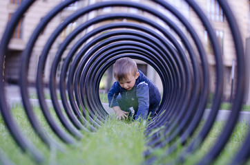 Boy playing in a tube