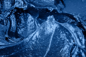 Classic blue background. Color of the year 2020. Top view, flat lay. Squeezed cosmetic cream texture, copy space