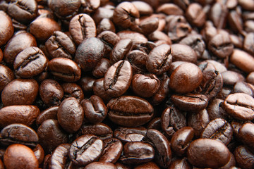 Roasted brown coffee beans background, above view? Close up
