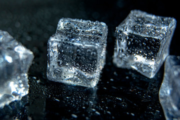 Ice cubes on reflection table with a drops of water- abstract photo