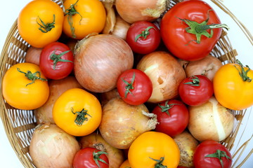 tomatoes and onions in a basket