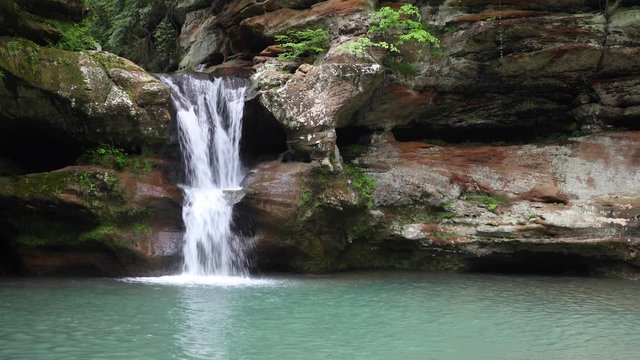 The beautiful Upper Falls at Old Man&rsquo;s Cave is a waterfall that cascades over a sandstone cliff in Hocking Hills State Park in Ohio. Looping video.