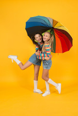 Safe place. Schoolgirls happy umbrella. Fall weather forecast. Safety concept. Fashion accessory. Girls friends with umbrella. Rainy day. Happy childhood. School time. Rainbow umbrella. Colorful life
