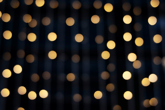 Blurred abstract hanging decorative lights with bokeh in dark background