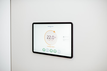 Digital touch screen panel for smart home managing with launched heating control application installed on the wall