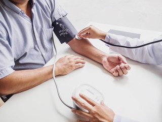 The doctor evaluates the patient with a stethoscope and records the results, health medical checkup concept