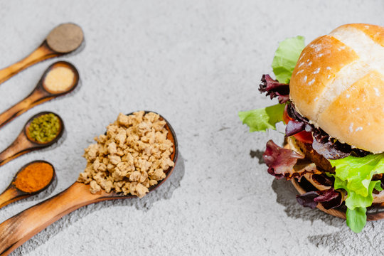 Soya Vegan burger on wooden background with vegetables. Healthy Vegan food.