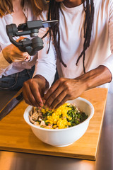 Girl taking the mobile with a grip recording a boy