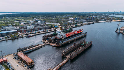 Naklejka premium Tanker vessel repair in dry dock Shipyard, Drone shot