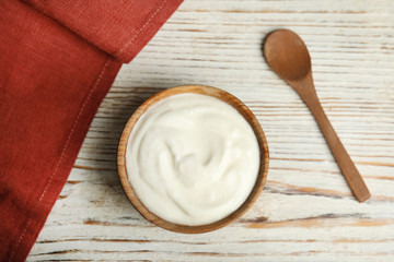 Tasty organic yogurt on white wooden table, flat lay