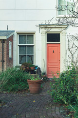 Red front door in historic urban home.