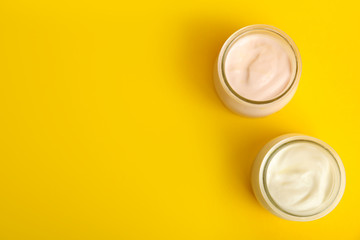 Tasty organic yogurt on yellow background, flat lay. Space for text