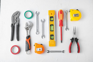Flat lay composition with construction tools on white background