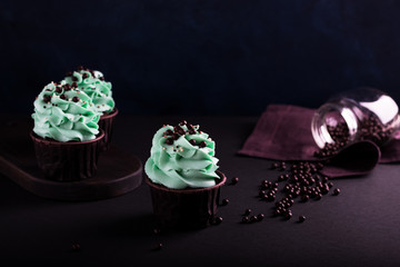 cupcakes and sprinkles on a dark background