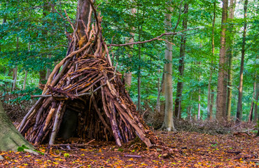 Tree hut made out of branches in the liesbos forest of breda, The netherlands