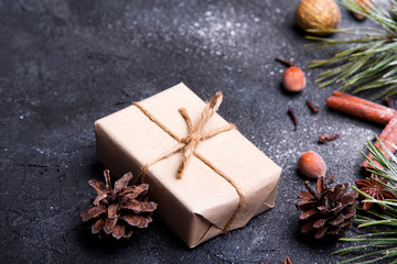  Christmas presents, pine twigs and cones covered with snow on dark background