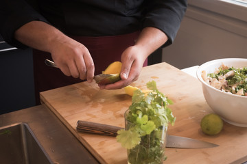 Cook's hands emptying a mango