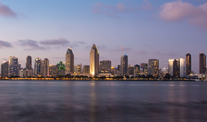 Fototapeta na wymiar San Diego skyline at dusk with San Diego Bay and clouds