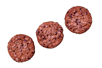 Three cookies with seeds isolated on white background. Selective focus.