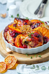 Chicken thighs baked with orange, garlic and cherry.