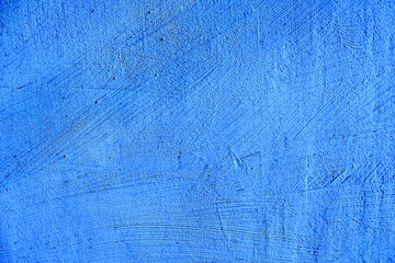 blue paint texture of old building wall with scratches and scuffs