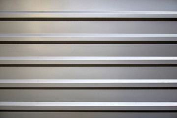 Obraz premium Profiled galvanized sheet with horizontal stripes. Partial lighting from above.