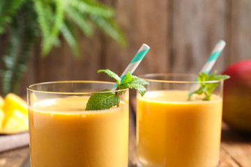 Fresh delicious mango drink on table, closeup