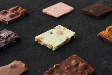 Сhocolate plates flat lay view on dark background, top of view