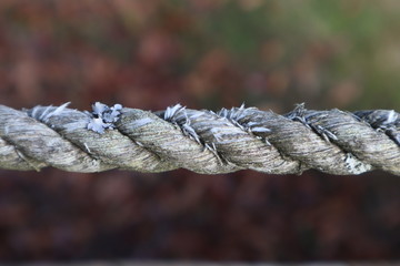 Closeup of a section of old, worn and frayed rope