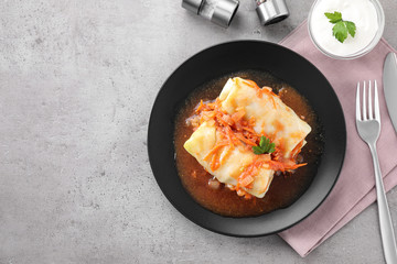 Delicious cabbage rolls served on grey table, flat lay