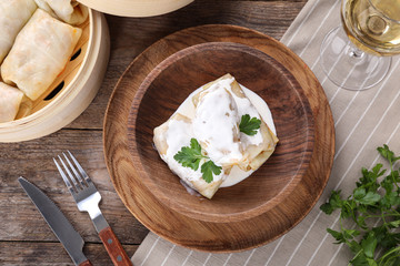 Delicious cabbage rolls served on wooden table, flat lay
