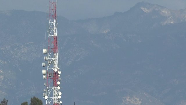 A large microwave communications tower on a hill 